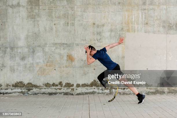 disabled athlete starting to run on street - limb body part stock pictures, royalty-free photos & images