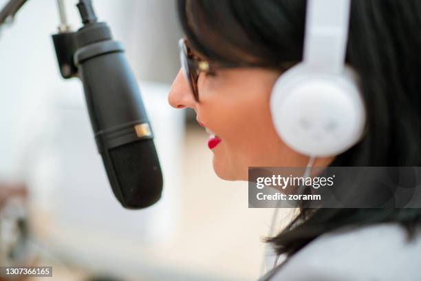 close-up of podcaster behind microphone - radio host stock pictures, royalty-free photos & images