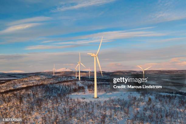 wind power stations in a winter landscape - wind energy stock pictures, royalty-free photos & images