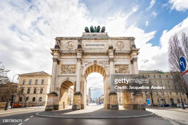 siegestor in munich, germany at the leopold street - munich stock pictures, royalty-free photos & images
