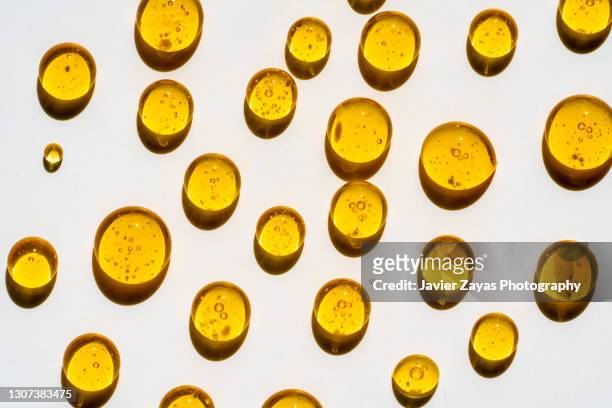 honey drops on a white colored background - essential oil bildbanksfoton och bilder
