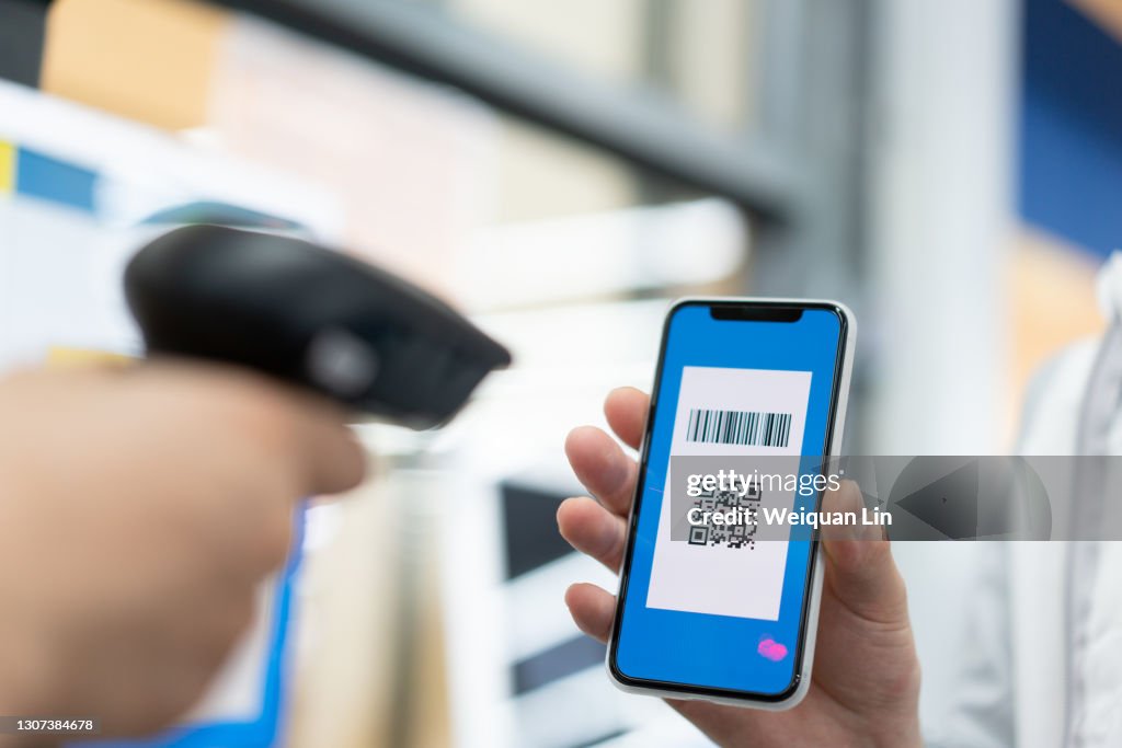Asian man is using mobile phone QR code to checkout