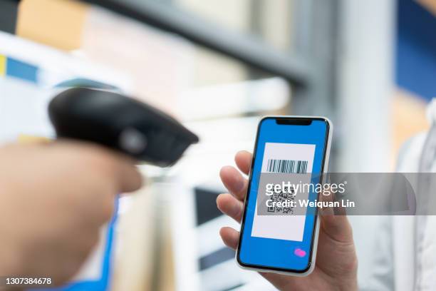asian man is using mobile phone qr code to checkout - bar code stock pictures, royalty-free photos & images
