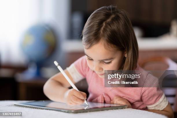 little child girl drawing on digital tablet using digitized pen - graphics tablet stock pictures, royalty-free photos & images