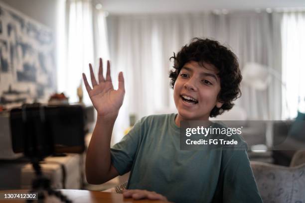 boy doing a video call on smartphone at home - children camera stock pictures, royalty-free photos & images