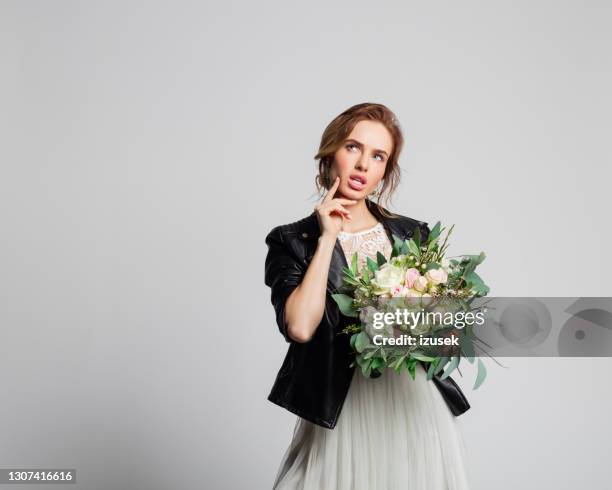 bride wearing weeding dress and leather jacket - wedding planning stock pictures, royalty-free photos & images