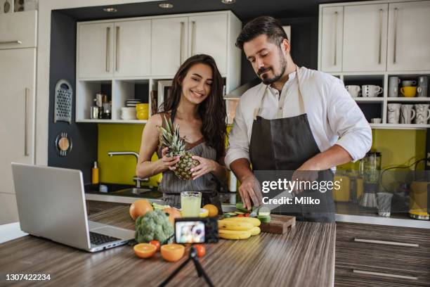 young couple vlogging about healthy eating - following recipe stock pictures, royalty-free photos & images