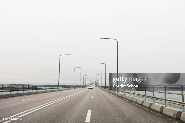 driving over the öland bridge on a cloudy spring day - kalmar bildbanksfoton och bilder