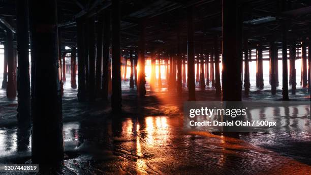 silhouette of pier over sea against sky during sunset,united states,usa - santa monica pier stock-fotos und bilder