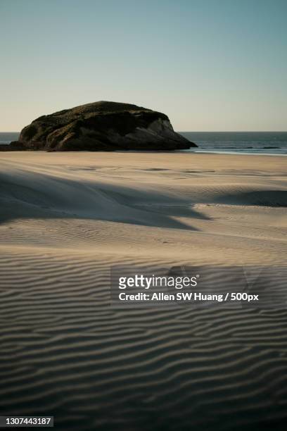 scenic view of beach against clear sky,puponga,new zealand - allen sw huang stock pictures, royalty-free photos & images