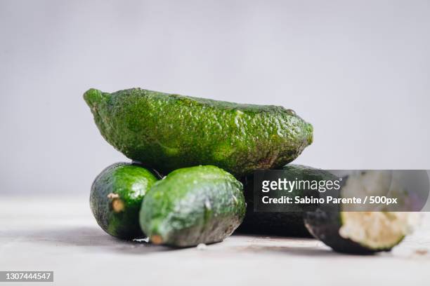 close-up of finger limes on white background - finger lime stock pictures, royalty-free photos & images