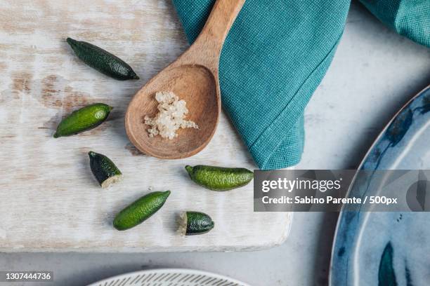 high angle view of finger limes on table - finger lime stock pictures, royalty-free photos & images