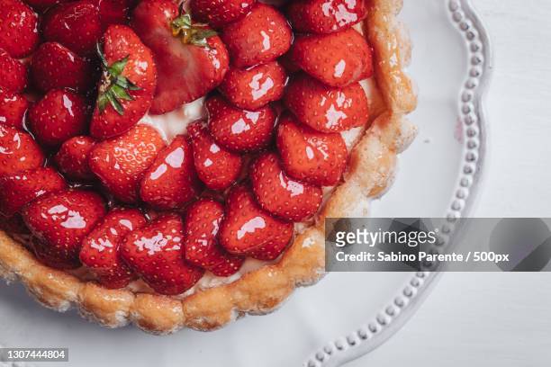 high angle view of tart in plate on table - strawberry tart stock pictures, royalty-free photos & images