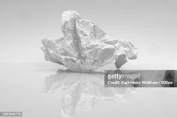 close-up of crumpled paper on white background - crumpled paper stock pictures, royalty-free photos & images