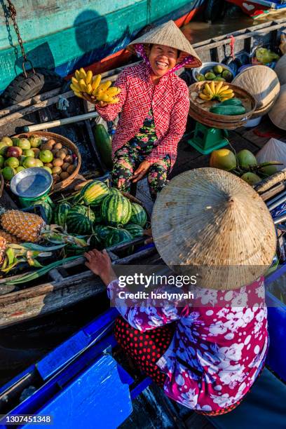 vietnamese woman selling bananas on floating market, mekong river delta, vietnam - vietnamese culture stock pictures, royalty-free photos & images