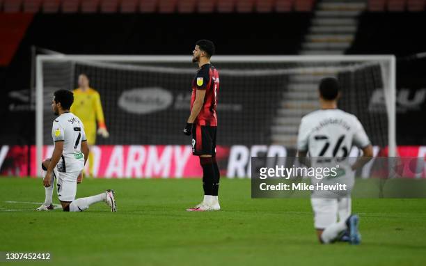 Dominic Solanke of AFC Bournemouth stands as Swansea City players take a knee in support of the Black Lives Matter movement prior to the Sky Bet...