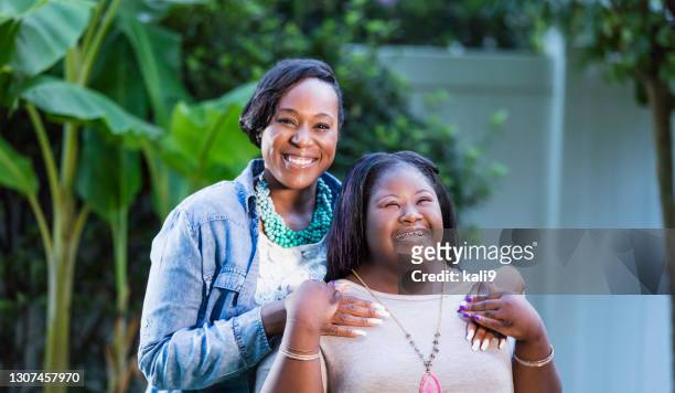 african-american mother and teen daughter with downs - young chubby girl stock pictures, royalty-free photos & images