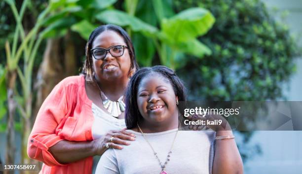 african-american grandmother and teen girl with downs - fat black girl stock pictures, royalty-free photos & images