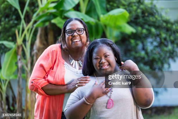 african-american grandmother and teen girl with downs - chubby girls stock pictures, royalty-free photos & images