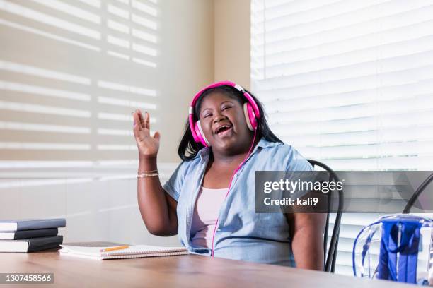 teenage girl with downs syndrome doing homework - chubby teenage girl imagens e fotografias de stock