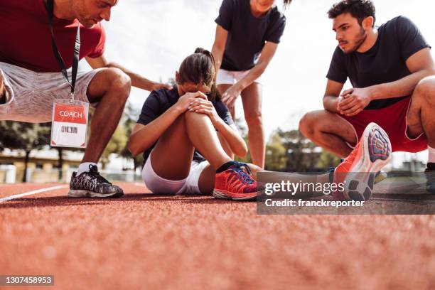 helping the injured athlete - injured runner stock pictures, royalty-free photos & images