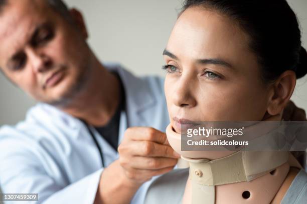 woman with neck brace - cervical collar stock pictures, royalty-free photos & images