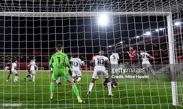 Dominic Solanke of AFC Bournemouth gets up for a header that deflects off Joel Latibeaudiere of Swansea City to score an own goal for AFC...