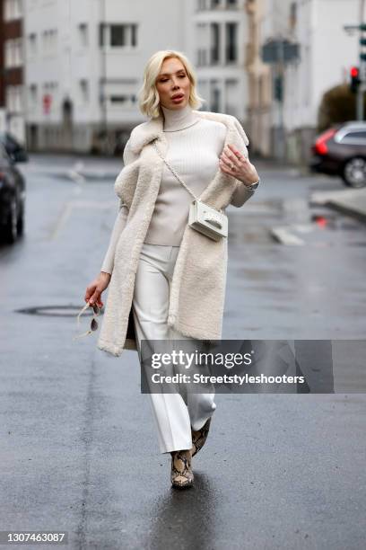 Hair stylist Svenja Simmons wearing a cream colored long teddy vest by Marsh, a cream colored turtleneck pullover by Rene Lezard, cream colored pants...