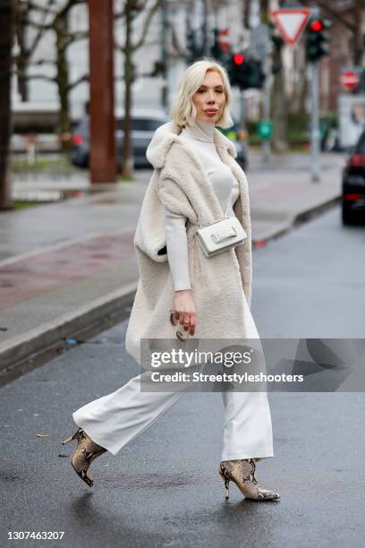 Hair stylist Svenja Simmons wearing a cream colored long teddy vest by Marsh, a cream colored turtleneck pullover by Rene Lezard, cream colored pants...