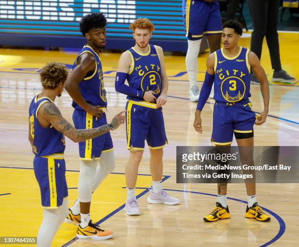 Golden State Warriors' Kelly Oubre Jr., #12 James Wiseman, #33 Nico Mannion and Jordan Poole talk during a timeout in the second quarter of their NBA...