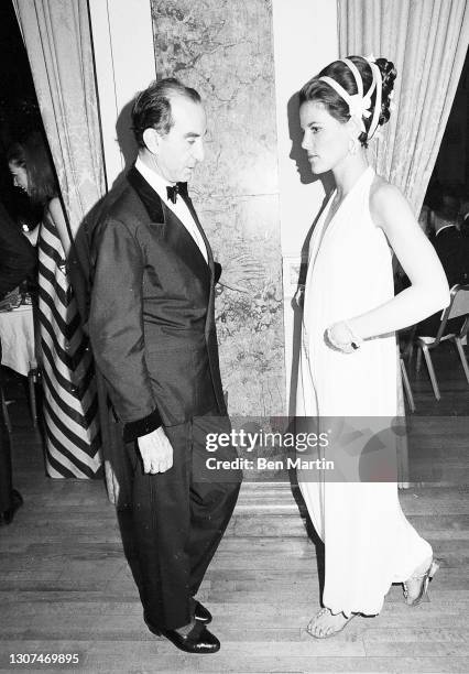 Italian fasjion designer Emilio Pucci chatting with Mrs Montague Hackett, who is wearing a Pucci gown inspired by Hermione in The Winter's Tale at...