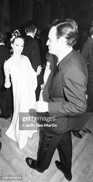 Photographer Bert Stern dancing with his wife, ballet dancer Allegra Kent, who is wearing a gown by Geoffrey Beane inspired by Cassandra in Troilus...