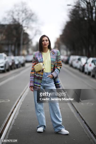Masha Sedgwick wearing weat yellow bag, Dries van Noten colourful blazer, The Frankie Shop yellow top, Levis blue wide jeans and Copenhagen Studios...