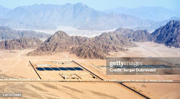 aerial view from the plane on solar panels in desert and mountains in sinai peninsula near sharm el sheikh, egypt - egypt desert stock pictures, royalty-free photos & images