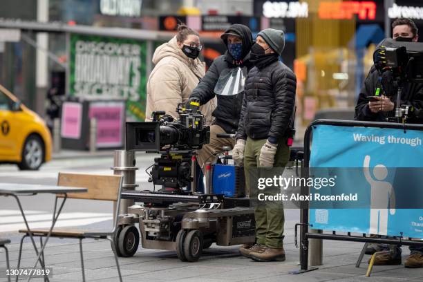 Camera crew wearing masks waits to film a scene onset of the 'FBI' TV Series in Times Square on March 16, 2021 in New York City. After undergoing...