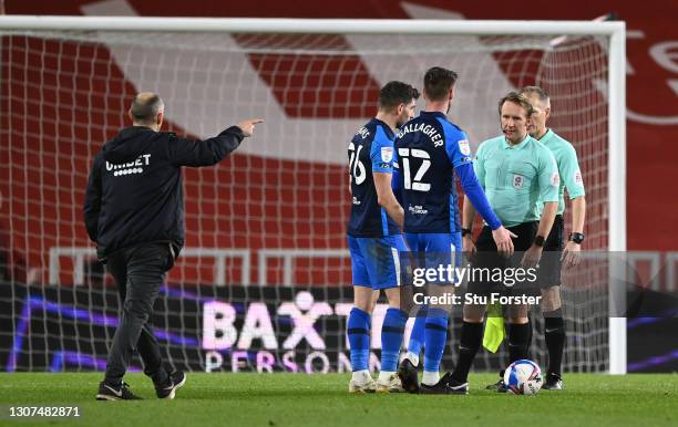 Preston manager Alex Neil heads over towards referee Oliver Langford as Preston players Ched Evans and Paul Gallagher question the referee during the...