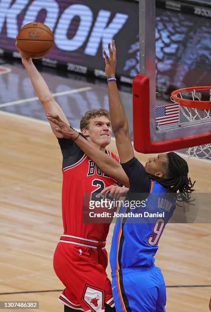 Lauri Markkanen of the Chicago Bulls goes up for a dunk against Moses Brown of the Oklahoma City Thunder at the United Center on March 16, 2021 in...