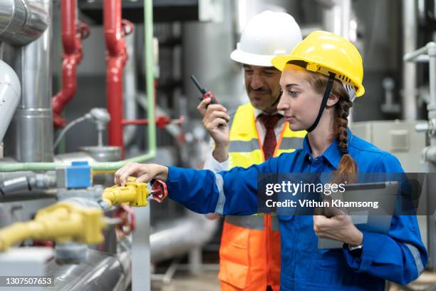 technician worker and engineer at industrial factory include machine and pipeline - oil and gas workers imagens e fotografias de stock