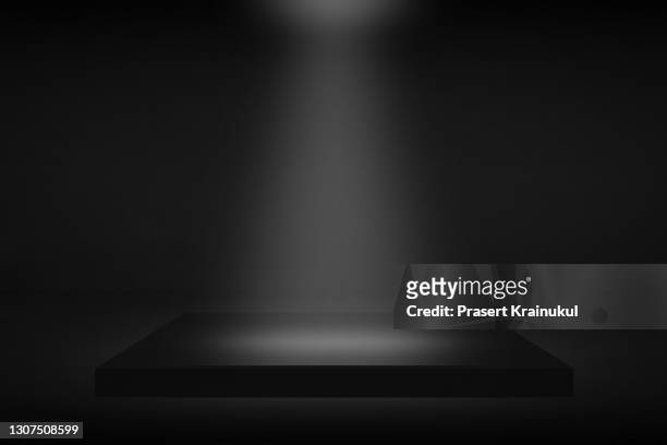 black background, dark stage background - spotlit fotografías e imágenes de stock