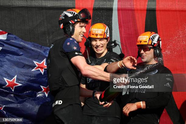 Emirates Team New Zealand member Peter Burling sprays champagne in celebration after winning race and the America's Cup against Luna Rossa Prada...