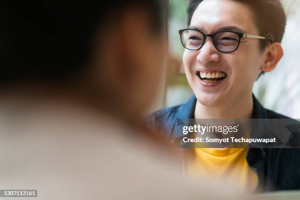 happiness smiling asian male casual meeting with his partner in cafe - asian male smiling foto e immagini stock