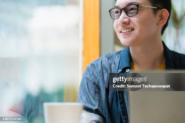 smart confidence asian startup entrepreneur business owner businessman smile hand hold coffee cup woking in cafe background - office small business stock-fotos und bilder