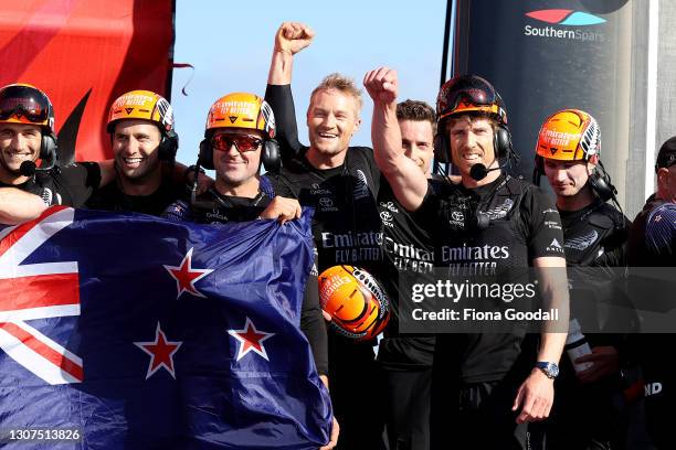 Emirates Team New Zealand members celebrate after winning race and the American's Cup against Luna Rossa Prada Pirelli Team on Auckland Harbour on...