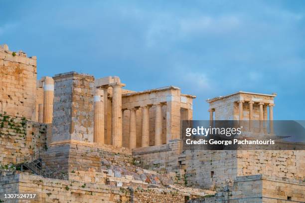 the propylaea and temple of athena nike at the acropolis of athens, greece - ancient greece stock pictures, royalty-free photos & images