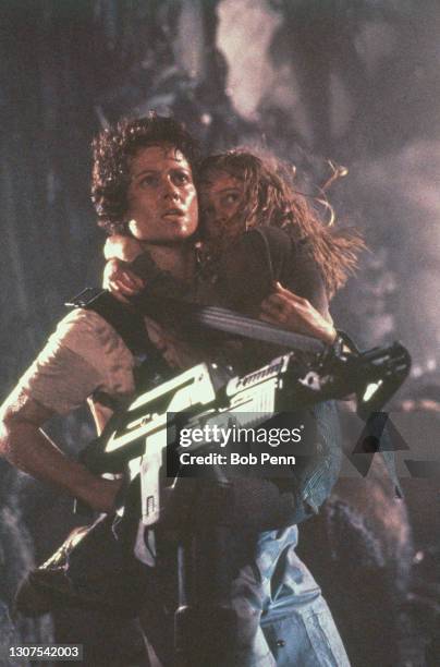 American actresses Sigourney Weaver and Carrie Henn on the set of the film Aliens II, directed by James Cameron.