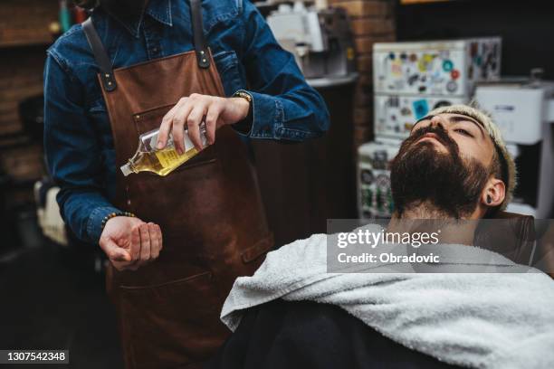 barber giving a haircut in his shop - ruffled hair stock pictures, royalty-free photos & images