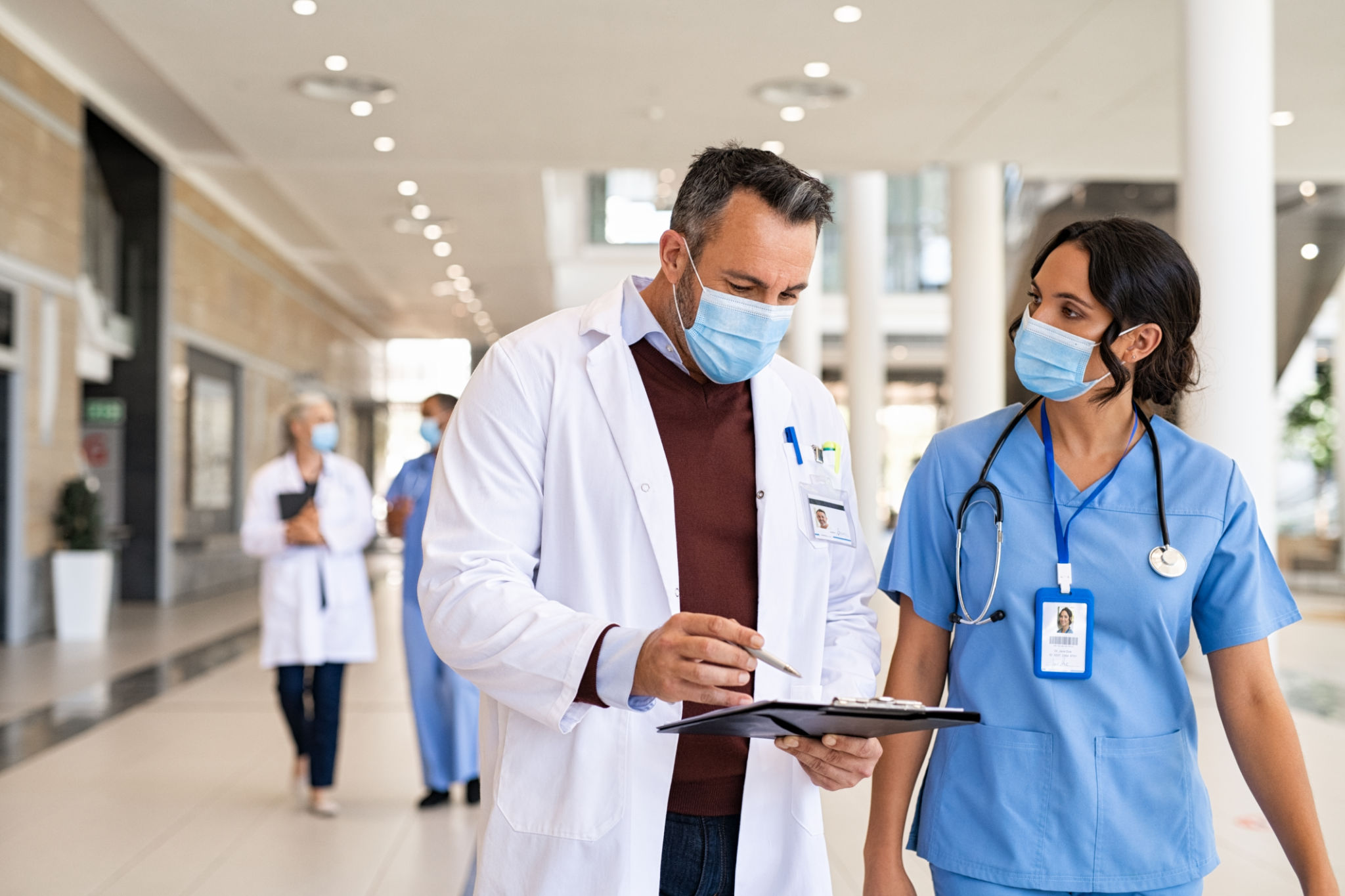 Mature doctor and nurse discussing patient case Mature doctor and nurse discussing patient case