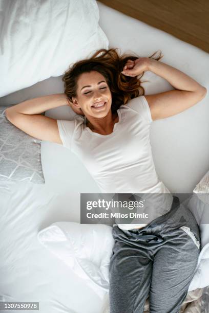 sick young woman is lying in bed stock photo - hot body pic stock pictures, royalty-free photos & images