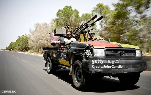 Fighters test-drive a Toyota Land Cruiser where the whole roof has been removed to accommodate a new gun conversion on September 4, 2011 in Misrata,...