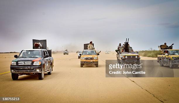 An NTC gun trucks set off for the frontline on October 3, 2011 in Sirte, Libya. Fighting in Libya has ceased following the killing of former leader...